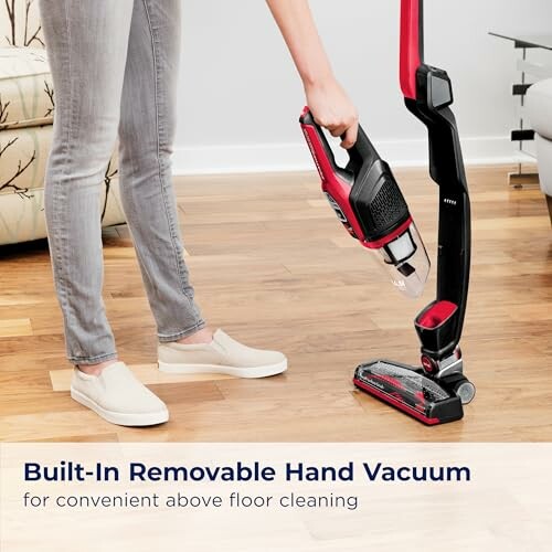 Person using a built-in removable hand vacuum for cleaning.