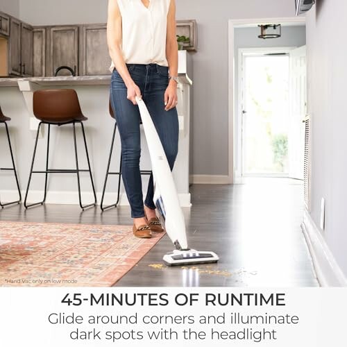 Person using a cordless vacuum on a rug with text about runtime.