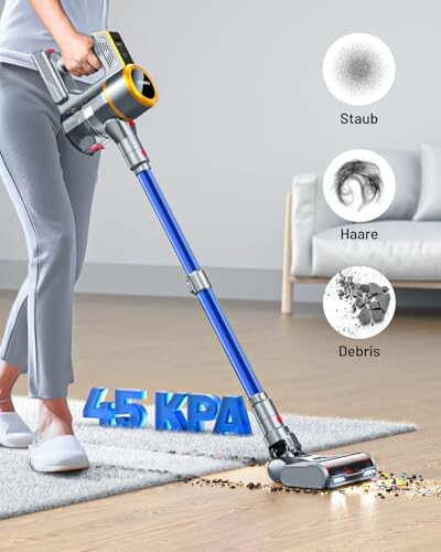 Person using a cordless vacuum cleaner on carpet with power rating and debris illustrations.