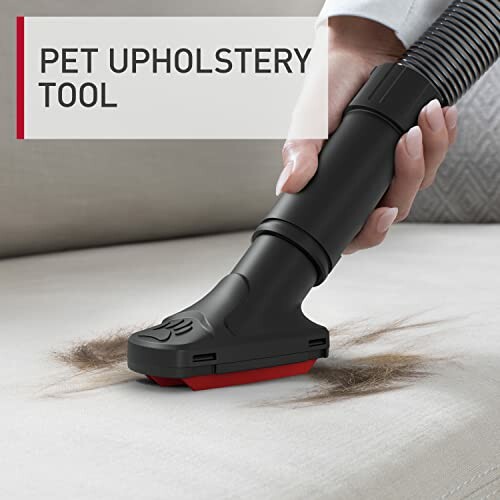 Pet upholstery tool vacuuming fur from fabric