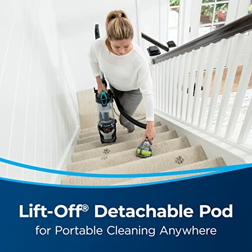 Person using a portable vacuum cleaner on carpeted stairs.