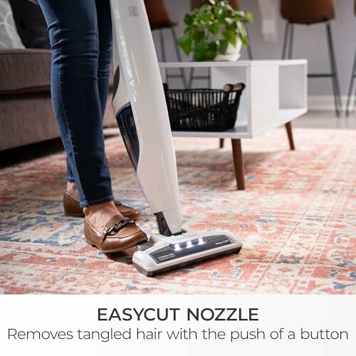 Person using vacuum cleaner with easycut nozzle on carpet