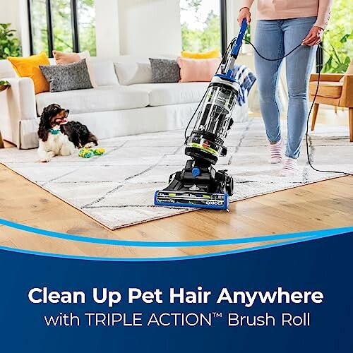Person using a vacuum cleaner on a carpet with a dog nearby.