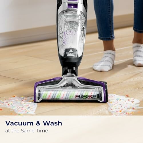 Vacuum cleaner washing a dirty floor with liquid and cereal.