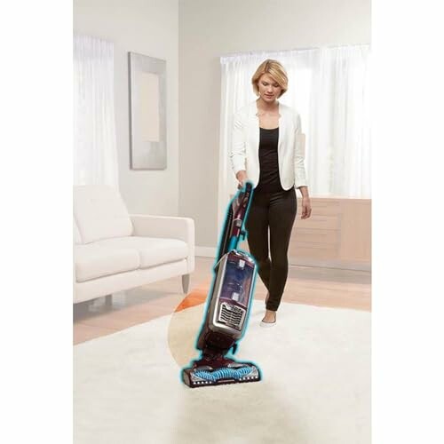 Woman using a vacuum cleaner in a living room.